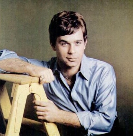 Lou Christie leaning on a wooden ladder, portrait